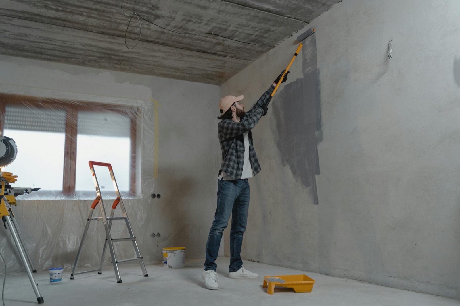Professional painter applying fresh paint to a commercial interior wall