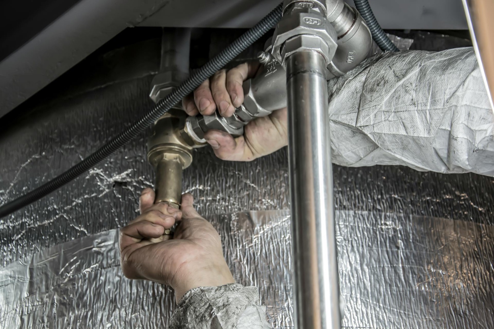 Plumber installing commercial pipe fittings